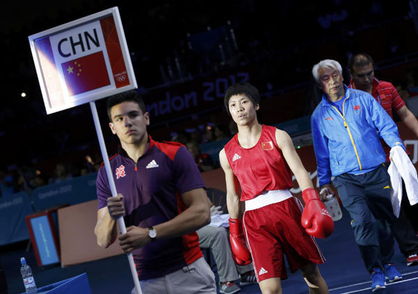 Ren Cancan of China walks to the ring for her fight against Russia's Elena Savelyeva during their quarterfinal Women's Fly (51kg) boxing match at the London Olympic Games, Aug 6, 2012. Olympic preview: The fight is on for gold on day 12