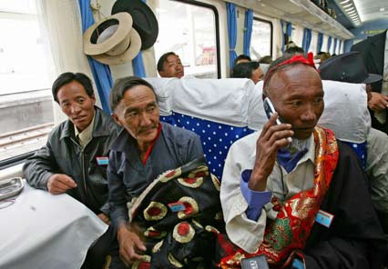 Passengers sit on board the first train at Lhasa railway station as it heads for Lanzhou in Gansu province July 1, 2006.