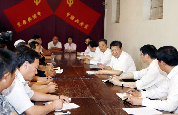 President Xi Jinping (3rd R) holds a discussion meeting with local cadres and representatives of the public at Xibaipo, an old revolutionary base in Pingshan county, north China's Hebei province, on July 12, 2013. Xi urges CPC members to keep China red