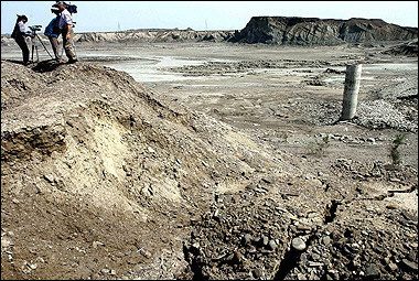 A Pakistani television crew film the damaged Shadi Kor Dam, in Pasni, which collapsed due to heavy rainfall sweeping villages and roads away. Disease threatened thousands of flood survivors as freak rains which have killed around 350 people across the country continued to pour down. [AFP]