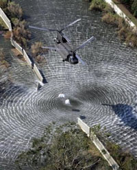 A military helicopter drops sandbags to repair a broken levee, Tuesday, Sept. 6, 2005, in New Orleans.