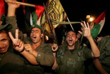 Palestinian security officers celebrate before their deployment inside vacated Jewish settlements in the southern Gaza Strip, September 11, 2005.