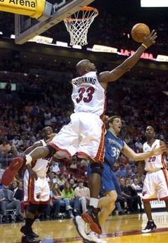 Miami Heat Alonzo Mourning (33) catches a rebound in front of Minnesota Timerwolves Mark Madsen (35) during the second quarter of an NBA basketball game, Sunday, Jan. 1, 2006, in Miami.