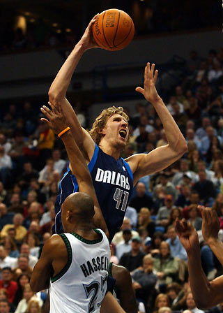 Dallas Mavericks forward Dirk Nowitzki (41) is fouled by Minnesota Timberwolves guard Trento Hassell (23) during the second half of their NBA game in the Target Center in Minneapolis January 4, 2006. Minnesota won 91-78. [Reuters]