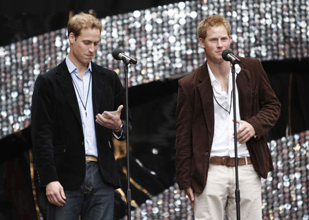 Britain's Princes William (L) and Harry speak on stage at Wembley Stadium in London at the