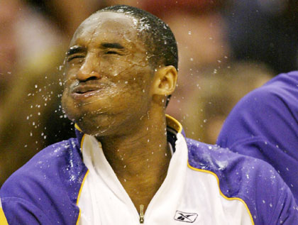 Los Angeles Lakers Kobe Bryant shakes his head after dousing himself with water during the fourth quarter of an NBA basketball game against the Phoenix Suns in Los Angeles, California, April 16, 2006.
