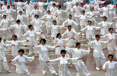 People practise tai-ji at a park where activities are held to mark a two-year-countdown to the 2008 Olympic Games in Beijing, August 8, 2006.