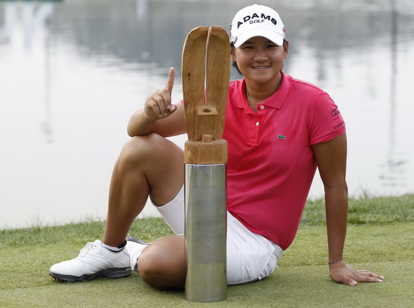 Yani Tseng of Taiwan poses for photographs with the trophy following her win at the 2011 LPGA HanaBank Championship golf tournament at Sky72 Golf Club Ocean course in Incheon, west of Seoul Oct 9, 2011. Top-ranked Tseng wins in South Korea