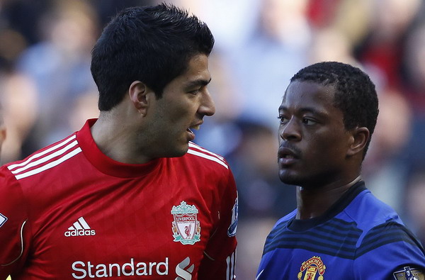 Liverpool's Luis Suarez (L) looks at Manchester United's Patrice Evra (R) during their English Premier League soccer match at Anfield in Liverpool, northern England Oct 15, 2011. Suarez 'upset' by Evra's racism allegation