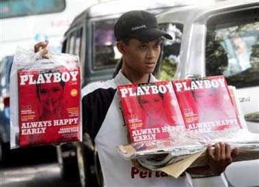 A street vendor sells first copies of a local version of Playboy magazine in Jakarta, Indonesia April 7, 2006. playboy