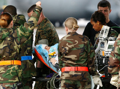 U.S. Air Force medical personnel carry CBS correspondent Kimberly Dozier from the U.S. on a stretcher out of an aircraft into an ambulance bus at Ramstein airbase in southwestern Germany May 30, 2006. Dozier was seriously wounded as a roadside bomb killed cameraman Paul Douglas, sound technician James Brolan, an U.S. soldier and an Iraqi contractor travelling with a U.S. military unit in Baghdad.