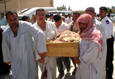 Iraqi residents carry the coffin of one of the 24 civilians who were dragged at a checkpoint and shot "execution style" in Udhaim, 120 km (80 miles) north of Baghdad, June 4, 2006.
