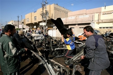 People clean up after a car bomb blast in predominantly Shiite area in eastern Baghdad, Iraq, Thursday, Jan. 31, 2007. At least one person was killed and six were wounded in the blast. (AP