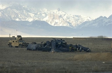 A U.S. military humvee guards the scene of a U.S. helicopter crash in the Shahjoi district of Zabul province in southeastern Afghanistan on Sunday Feb. 18, 2007.