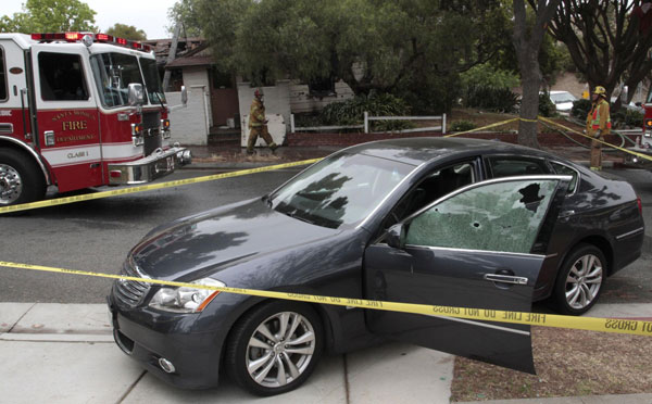 A vehicle sits on the side of a road with a window shattered by bullets that an eyewitness says is connected to a shooting a few blocks away on the campus of Santa Monica College in Santa Monica, California, June 7, 2013. Police: Gunman killed 4 in California shootings