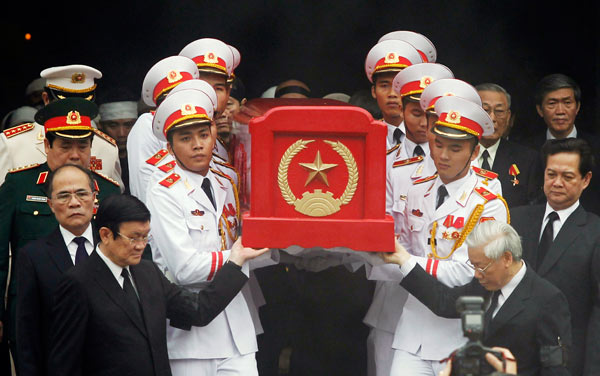 Vietnamese President Truong Tan Sang (front left), Vietnamese Prime Minister Nguyen Tan Dung (far right), along with leaders and soldiers, carry the coffin of the late General Vo Nguyen Giap during his funeral at the National Funeral House in Hanoi on Sunday Vietnam buries heroic general