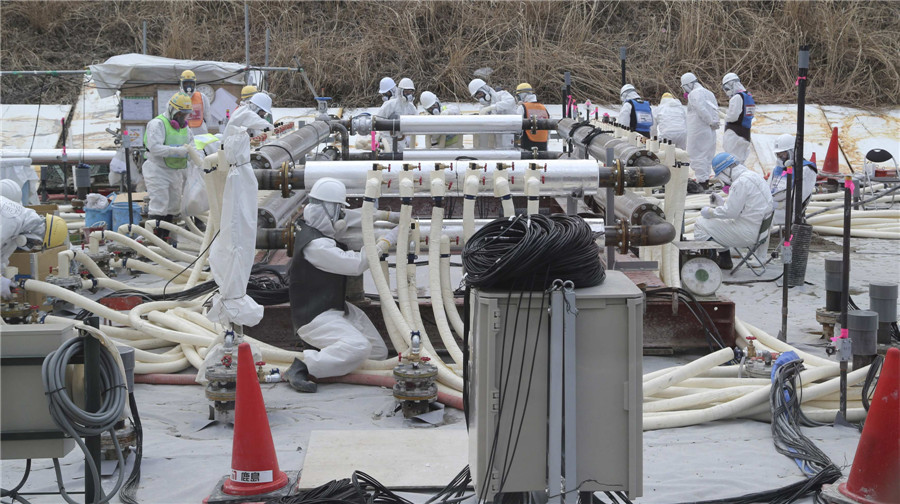 Workers build an underground frozen wall at Tokyo Electric Power Co's (TEPCO) tsunami-crippled Fukushima Daiichi nuclear power plant in Fukushima prefecture March 10, 2014. Visit to Fukushima nuclear plant on meltdown anniversary